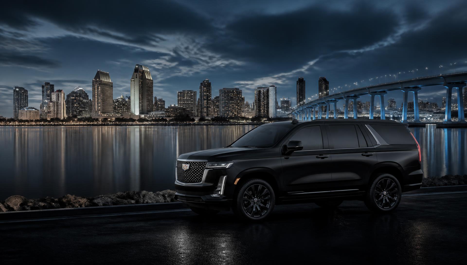 Black SUV traveling along the waterfront with the downtown San Diego skyline behind it
